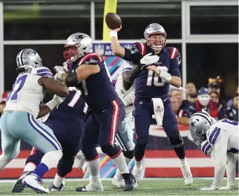  ?? NAncy lAnE pHOtOs / HErAld stAff filE ?? TIME TO DELIVER: Patriots quarterbac­k Mac Jones gets off a pass under pressure during overtime against the Cowboys on Sunday at Gillette Stadium.