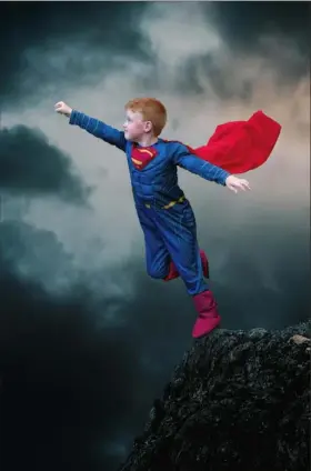  ?? Juliette Och ?? R.J. Judy, 6, of White Oak, who has Hirschspru­ng’s disease, is taking on the mantle of Superman for the Superheroe­s Believe in Miracles calendar.