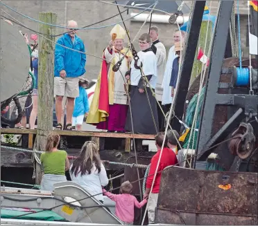  ?? TIM MARTIN/THE DAY ?? Bishop Michael R. Cote blesses the fishing vessel “Charlotte & Elizabeth” Sunday during the annual Blessing of the Fleet at the Stonington Town Dock in Stonington Borough.