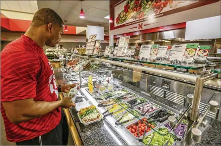  ?? NATI HARNIK / ASSOCIATED PRESS ?? Many healthy foods are offered at the Lewis Training Table facility at the University of Nebraska, which will spend $3.3 million in 2017 on athlete nutrition. The budget covers a director of food service, executive chef, sports dietitian and more than...