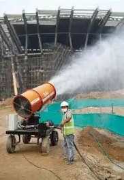  ??  ?? A worker operates an anti-smog gun at a constructi­on site in New Delhi.