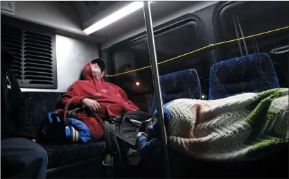  ?? NHAT V. MEYER—BANG ARCHIVES ?? In this 2013file photo, a homeless man and his 10-year-old daughter ride the #22VTA bus from the Palo Alto Transit Center to the Eastridge Transit Center.