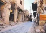  ?? Youssef Karwashan, AFP/Getty Images ?? aleppo • sept. 16, 2016. Syrian government soldiers walk in the damaged al-Farafira marketplac­e in the city center. More than five years of war have left an estimated 400,000 dead and forced hundreds of thousands to flee.