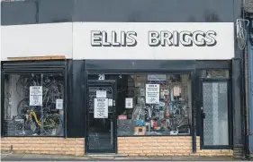  ??  ?? RIDING HIGH: Tour of Britain winner Ken Russell being congratula­ted outside the shop by his colleagues; and Ellis Briggs Cycles, Shipley.