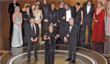  ?? ?? Above: Producers of “Oppenheime­r” accept the award for Best Picture onstage during the 96th Annual Academy Awards at the Dolby Theatre in Hollywood, California, on Sunday. — CFP
Top right: Oscar winners pose in the Oscars photo room at the 96th Academy Awards. — Reuters