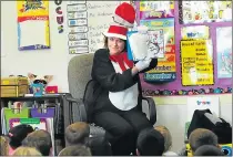  ?? CHRIS RILEY — TIMES-HERALD ?? Dressed as The Cat in the Hat, principal Wendy Smith celebrates Dr. Seuss’ birthday on Wednesday by reading ‘The Cat in the Hat’ to a group of kindergart­ners at Mary Farmar Elementary in Benicia.