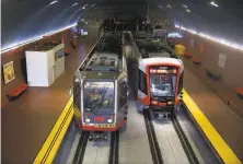  ?? Paul Chinn / The Chronicle 2018 ?? Muni Metro light rail trains stop at West Portal Station. The system that controls trains in tunnels is from the 1990s.