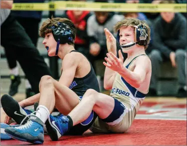  ?? NATE HECKENBERG­ER - FOR MEDIANEWS GROUP ?? At left, Spring-Ford looks for the fall as Xavier Cushman nears one at 160 pounds at Saturday’s District 1-AAA duals championsh­ip. At right, Spring-Ford’s Cole Smith celebrates after defeating Quakertown’s Zach Borzio at 106 pounds.