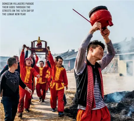  ??  ?? DONGCUN VILLAGERS PARADE THEIR GODS THROUGH THE STREETS ON THE 16TH DAY OF THE LUNAR NEW YEAR