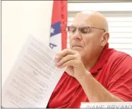  ?? LYNN KUTTER ENTERPRISE-LEADER ?? Farmington City Council member Bobby Morgan looks over the Waste Management contract before voting to approve it for the next five years.