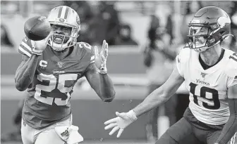  ?? Tony Avelar / Associated Press ?? 49ers cornerback Richard Sherman intercepts a pass in front of Vikings receiver Adam Thielen during the second half of their playoff game on Saturday.