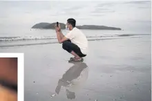  ??  ?? Rohingya refugee “Abdu Hamid” (using a pseudonym) holds his mobile phone on the Malaysian island of Langkawi, during a video call with his wife who is living at the Kutupalong refugee camp in southern Bangladesh.