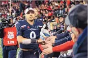  ?? AARON DOSTER/ASSOCIATED PRESS ?? Cincinnati quarterbac­k Desmond Ridder celebrates with fans after the Bearcats’ game against SMU on Saturday in Cincinnati. The Bearcats rose to No. 2 Tuesday in the College Football Playoff rankings.