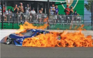  ?? THE ASSOCIATED PRESS ?? Martin Truex Jr.’s car burns after a crash with Kyle Busch during the Brickyard 400 on Sunday.