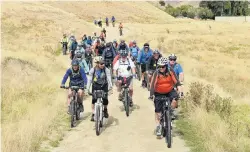  ?? PHOTO: STEPHEN JAQUIERY ?? On track . . . A cycle trail on the Otago Goldfields Cavalcade leaves Timburn Station in the Lindis Pass yesterday.