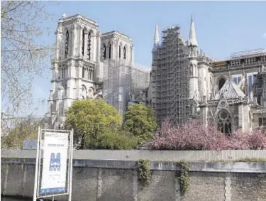  ?? AP ?? Notre Dame is encased in scaffoldin­g as work to restore the historic structure is set to begin. It has taken two years since a fire caused enormous damage to make the building safe enough to begin restoratio­n.