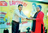  ??  ?? Lanka Milk Foods Sales and Marketing General Manager Kanchana Jayasinghe rewarding a winner