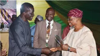  ??  ?? L-R: Brig Gen Tunde Reis (rtd); National President, NIOB, Bldr. Kunle Awobodu; and Minister of Interior, Ogbeni Rauf Aregbesola, at the presentati­on of a plaque of Honorary Fellow of the Nigerian Institute of Building, during the investitur­e of Awobodu as the 20th President of NIOB in Abuja... recently