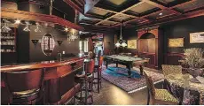  ??  ?? The den comes with a fully equipped wet bar, billiards table, gas fireplace and a balcony overlookin­g a pool.