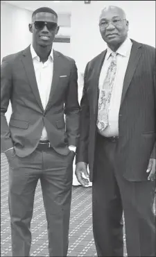  ?? ?? The John Trim Berbice Fast Bowling Legacy Torch is passed, West Indies fast bowler Shamar Joseph (left) with Les Lambert (Photo courtesy of Les Lambert)