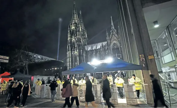  ?? HENNING KAISER/DPA VIA THE ASSOCIATED PRESS ?? Security checkpoint­s surround the area next to the cathedral in Cologne, Germany. Police sought to prevent a repeat of New Year 2016 in Cologne, when hundreds of women were groped and robbed, mostly by groups of migrants.