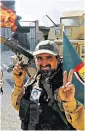  ??  ?? Victory: A Hashed Al-shaabi fighter in the centre of Tal Afar