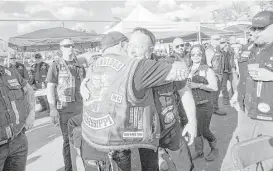  ?? Jon Shapley / Houston Chronicle ?? Jeff Pike, former Bandidos Motorcycle Club president, center-right, is greeted by members at the group’s 50th anniversar­y party on March 12 in Kingwood.