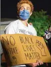  ?? ANDREW CULLEN / NEW YORK TIMES ?? A protester holds a sign during a demonstrat­ion Monday after a Black man was shot by Los Angeles County sheriff’s deputies.