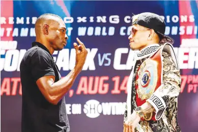  ??  ?? JOHN RIEL CASIMERO (right) and Cuban Guillermo Rigondeaux in a stare-down at the media launch on the eve of their WBO welterweig­ht fight in Carson, California. (Showtime Boxing)