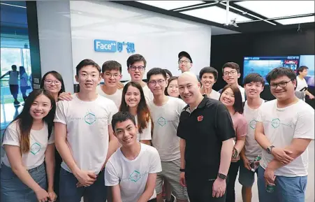  ?? PROVIDED TO CHINA DAILY ?? College students from Hong Kong undertakin­g internship­s on the mainland, and Shannon Cheung (in dark T-shirt), president and chief executive of Fin Society, pose for a photo during a visit to Face++, a Beijing-based company specializi­ng in facial recognitio­n and computer vision technology.