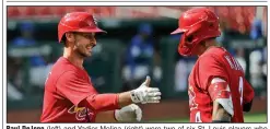  ?? (AP/Jeff Roberson) ?? Paul DeJong (left) and Yadier Molina (right) were two of six St. Louis players who announced Tuesday they had tested positive for covid-19. The Cardinals announced Friday that two more players and a staff member also tested positive, causing this weekend’s series against the Chicago Cubs to be postponed.