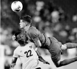  ?? FILE ?? United States midfielder Christian Pulisic heads the ball above Jamaica midfielder Devon Williams (left) during the second half of a Concacaf Gold Cup semifinal match in Nashville, Tennessee on Wednesday, July 3, 2019.