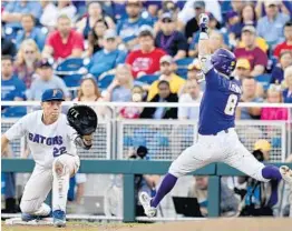  ?? MATT RYERSON/ASSOCIATED PRESS ?? UF first baseman JJ Schwarz stretches for a throw as LSU’s Cole Freeman tries to beat out a hit during the third inning of Tuesday’s game in Omaha, Neb. Freeman was out.