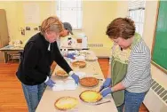  ?? ?? Volunteers slice up pies for the 56th annual event.