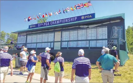  ??  ?? TERRY KOCONScore­board graphic artist Terry Kocon created the calligraph­y used on this scoreboard at the PGA Championsh­ip at Whistling Straits. To her dismay, a strong thundersto­rm on Friday destroyed it.