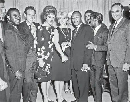  ?? Cal State Nor thridge ?? THIS PHOTO by Harry Adams shows the Rev. Martin Luther King Jr., fourth from right, with dignitarie­s including Ralph Abernathy, Paul Newman, Joanne Woodward, Sammy Davis Jr., Marlon Brando and others during King’s 1963 visit to L.A. for a civil rights...