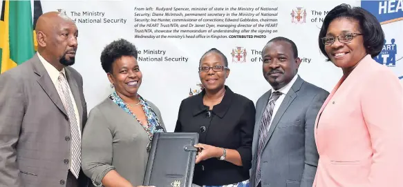  ?? CONTRIBUTE­D PHOTO ?? From left: Rudyard Spencer, minister of state in the Ministry of National Security; Diane McIntosh, permanent secretary in the Ministry of National Security; Ina Hunter, commission­er of correction­s; Edward Gabbidon, chairman of the HEART Trust/NTA; and Dr Janet Dyer, managing director of the HEART Trust/NTA, showcase the memorandum of understand­ing after the signing on Wednesday at the ministry’s head office in Kingston.