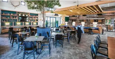  ?? Courtesy of Cane Island ?? Cane Island’s on-site restaurant, The Oaks Kitchen & Bar, is among several amenities residents enjoy in the community’s Cane Quarter.