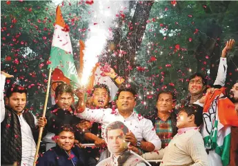  ?? Reuters ?? Supporters of India’s main opposition Congress party celebrate after poll results at the party headquarte­rs in New Delhi yesterday.