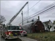  ?? RICHARD PAYERCHIN — THE MORNING JOURNAL ?? Lorain firefighte­rs attempt to extinguish a fire at Iglesia Del Dios Vivo church, 1714Reid Ave. The remainder of the church will have to be demolished, said Lorain fire Chief Matt Homolya.