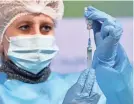  ?? GETTY IMAGES ?? A medical worker draws up a dose of the Oxford/AstraZenec­a vaccine during vaccinatio­ns of priests in Kiev, Ukraine, on Tuesday.