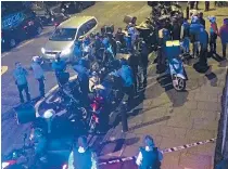  ??  ?? Food delivery riders arrive at the scene of one of the attacks amid fears that robbers were targeting their colleagues in east London on Thursday night
