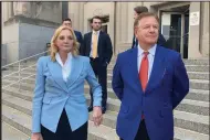  ?? (AP/Jim Salter) ?? Patricia McCloskey (left) and her husband Mark McCloskey leave court after a hearing Thursday in St. Louis.