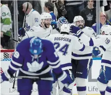  ?? FRANK GUNN THE CANADIAN PRESS ?? Tampa Bay Lightning players celebrate defeating the Toronto Maple Leafs in Game 7 of their first-round playoff series Saturday night in Toronto.