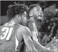  ?? AP/Athens Banner-Herald/JOSHUA L. JONES ?? Arkansas guard Anton Beard tries to defend Georgia forward Yante Maten during the Razorbacks’ 80-77, double-overtime victory over the Bulldogs on Tuesday in Athens, Ga. Maten scored 26 points and grabbed 15 rebounds for Georgia.