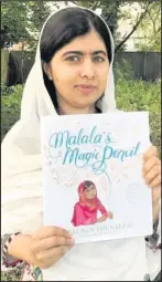  ??  ?? Nobel Prize winner Malala Yousafzai with a copy of her book Malala’s Magic Pencil, whose title text and surroundin­g embellishm­ents were produced by renowned Hinckley-based illustrato­r Sarah J Coleman, better-known as Inkymole, October 2017