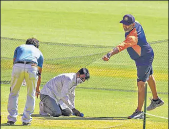  ?? PTI ?? India bowling coach Bharat Arun inspects the pitch in Ahmedabad on Wednesday.