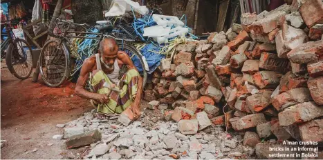  ?? ?? A man crushes bricks in an informal settlement in Bolaka