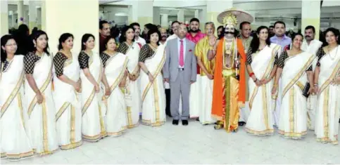  ??  ?? KUWAIT: Indian Ambassador Sunil Jain poses for a photograph with ladies in their traditiona­l Kerala attire during an Onam celebratio­n.