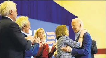  ?? Alex Brandon Associated Press ?? PRESIDENT BIDEN, right, hugs Kathleen Kennedy Townsend during a campaign event in Philadelph­ia on Thursday. With them are Maxwell Kennedy Sr., left, Joe Kennedy III and Kerry Kennedy.